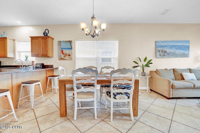 tiled dining space featuring an inviting chandelier