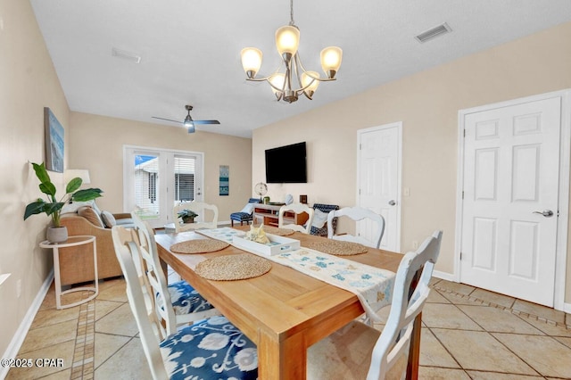 tiled dining area featuring ceiling fan with notable chandelier