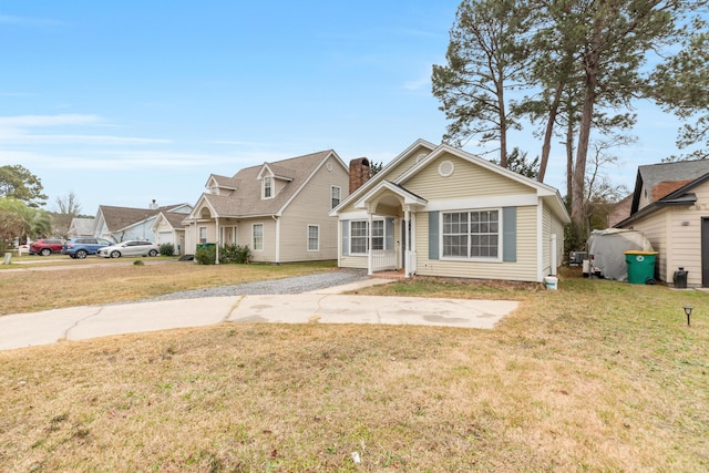 bungalow featuring a residential view, driveway, and a front lawn