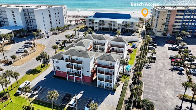 drone / aerial view featuring a water view and a view of the beach