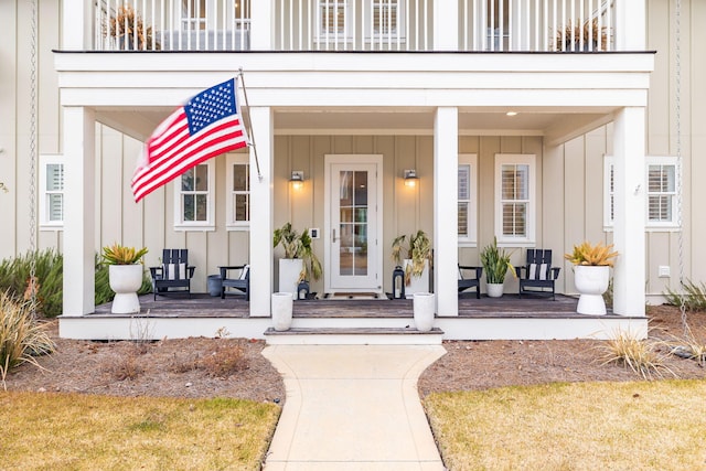 doorway to property with a balcony and covered porch