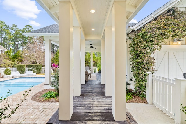 view of patio / terrace featuring a fenced in pool and ceiling fan