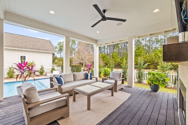 sunroom / solarium featuring ceiling fan