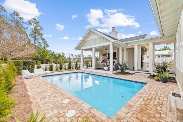 view of swimming pool with ceiling fan and a patio area