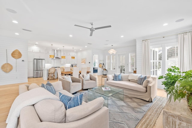 living room featuring ceiling fan and light wood-type flooring