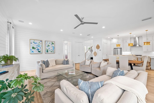 living room featuring ceiling fan and light wood-type flooring