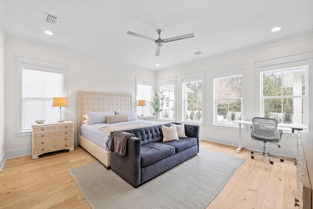 bedroom featuring light hardwood / wood-style flooring, ornamental molding, and ceiling fan