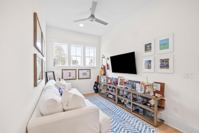 living room with ceiling fan and light wood-type flooring