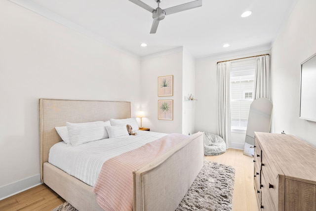 bedroom featuring ornamental molding, light hardwood / wood-style floors, and ceiling fan