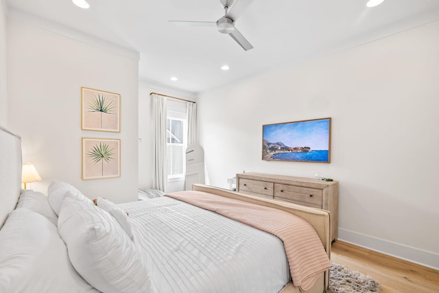 bedroom with ceiling fan and light hardwood / wood-style flooring