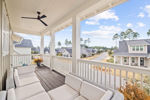 balcony with an outdoor living space and ceiling fan