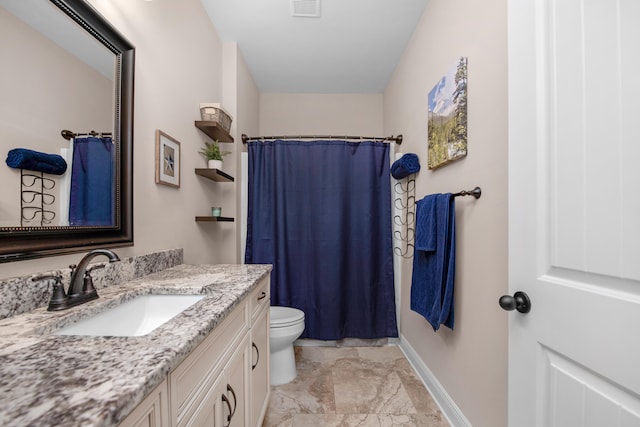 bathroom with vanity, toilet, and curtained shower