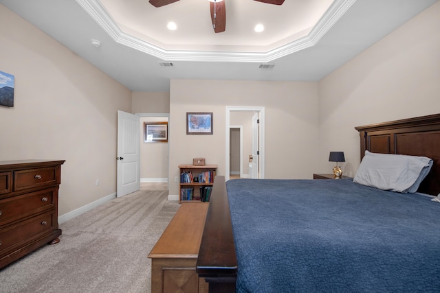 carpeted bedroom featuring crown molding, ceiling fan, and a tray ceiling