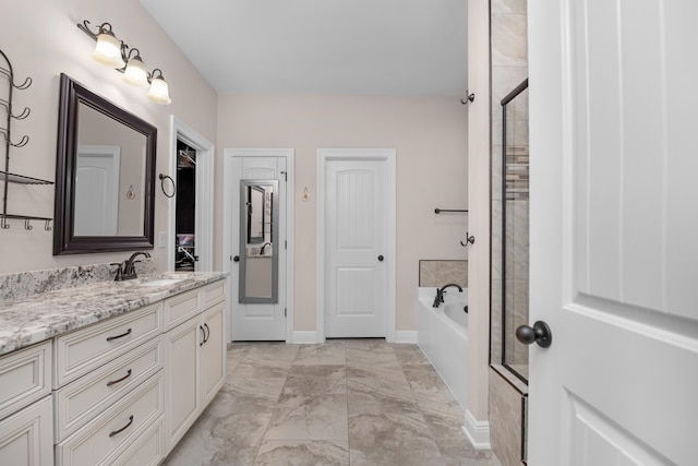 bathroom with vanity and separate shower and tub