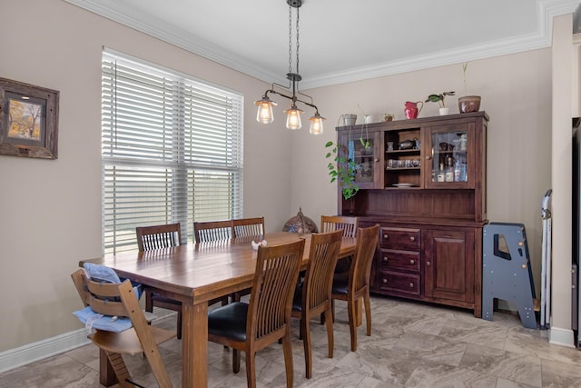 dining space with crown molding