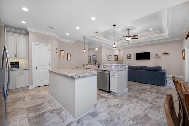 kitchen featuring sink, a center island, hanging light fixtures, stainless steel appliances, and light stone countertops