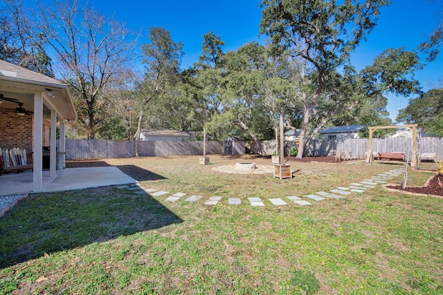 view of yard featuring ceiling fan and a patio area