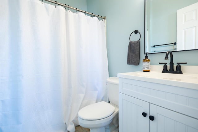 bathroom featuring a shower with curtain, vanity, and toilet