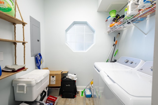 washroom featuring hardwood / wood-style flooring, washer and dryer, and electric panel