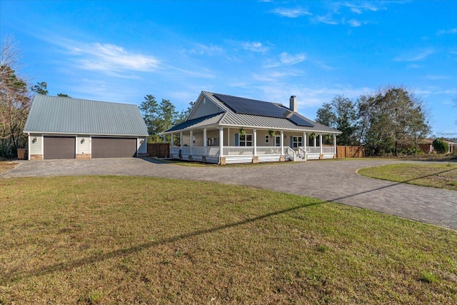 farmhouse featuring a porch, roof mounted solar panels, driveway, and a front lawn