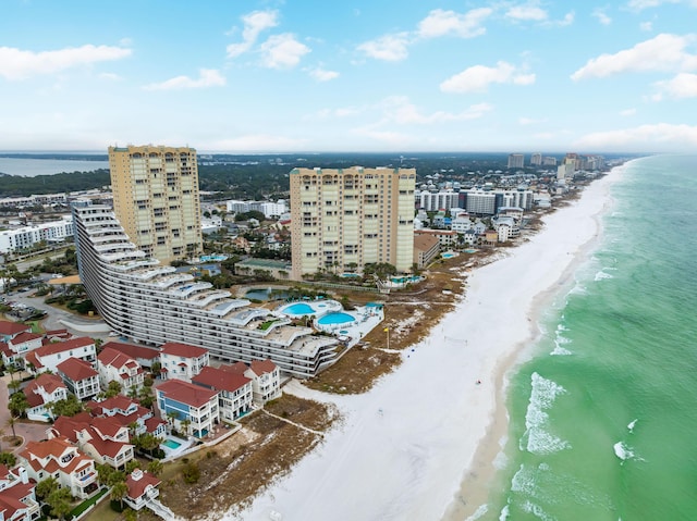 birds eye view of property with a beach view, a water view, and a city view