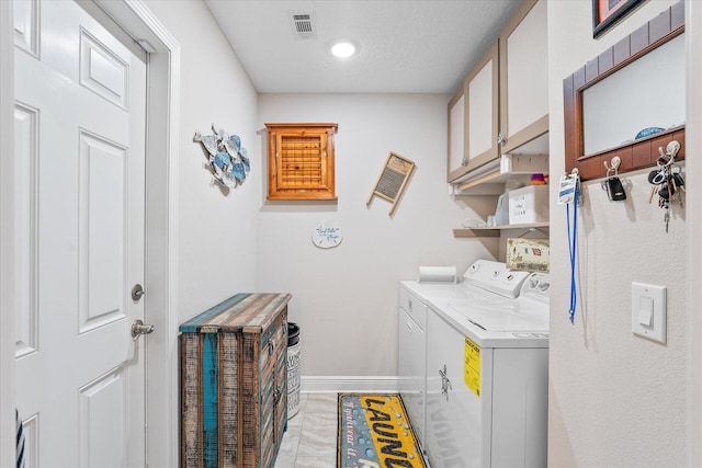 1911 Ladybird Ln, Gulf Breeze, FL 32563 - washroom featuring baseboards, visible vents, washing machine and clothes dryer, and cabinet space