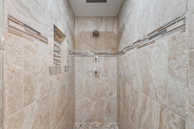 1911 Ladybird Ln, Gulf Breeze, FL 32563 - bathroom with a tile shower and a textured ceiling
