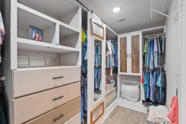 1911 Ladybird Ln, Gulf Breeze, FL 32563 - walk in closet featuring wood finished floors and visible vents