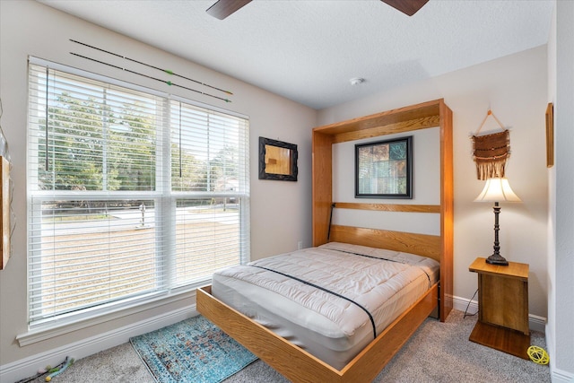 1911 Ladybird Ln, Gulf Breeze, FL 32563 - carpeted bedroom featuring baseboards, ceiling fan, and a textured ceiling