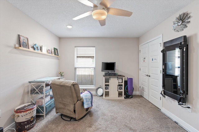 1911 Ladybird Ln, Gulf Breeze, FL 32563 - living area featuring a textured ceiling, ceiling fan, baseboards, and carpet