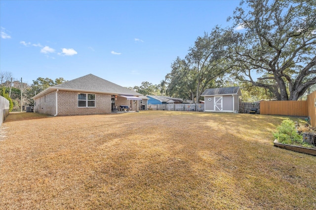 1911 Ladybird Ln, Gulf Breeze, FL 32563 - view of yard with central AC, a fenced backyard, a storage unit, an outdoor structure, and a patio area