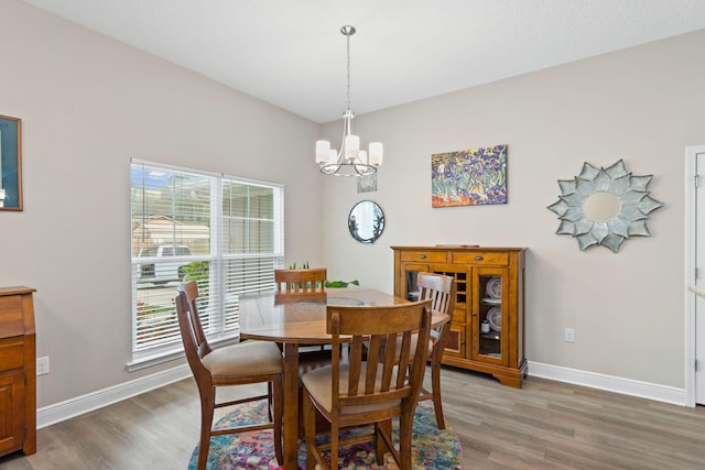 1911 Ladybird Ln, Gulf Breeze, FL 32563 - dining area featuring baseboards, light wood-style floors, and an inviting chandelier