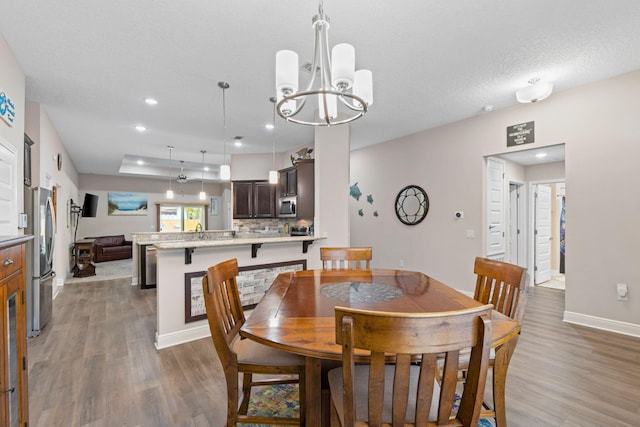 1911 Ladybird Ln, Gulf Breeze, FL 32563 - dining space featuring an inviting chandelier, recessed lighting, baseboards, and wood finished floors