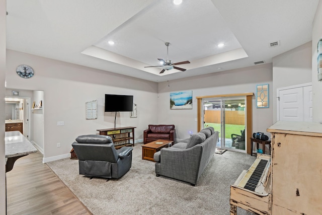 1911 Ladybird Ln, Gulf Breeze, FL 32563 - living area with a tray ceiling, baseboards, visible vents, and ceiling fan