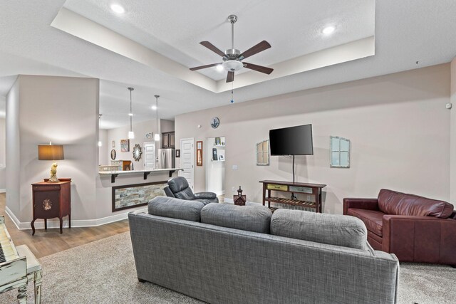 1911 Ladybird Ln, Gulf Breeze, FL 32563 - living room with baseboards, ceiling fan, recessed lighting, a raised ceiling, and light wood-style floors