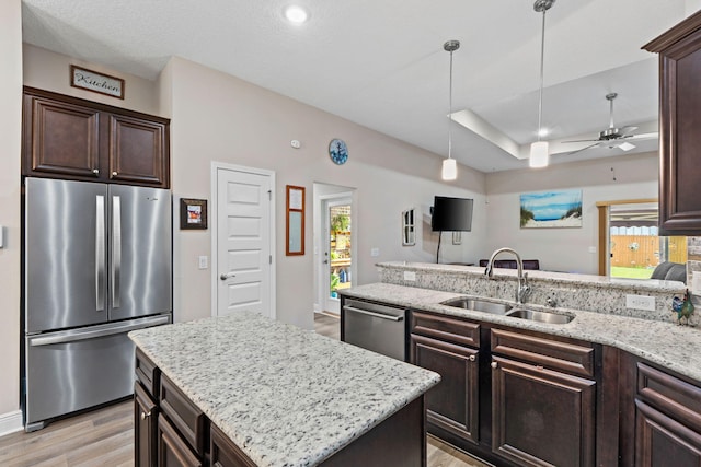 1911 Ladybird Ln, Gulf Breeze, FL 32563 - kitchen with a sink, light stone counters, light wood-style flooring, dark brown cabinetry, and appliances with stainless steel finishes