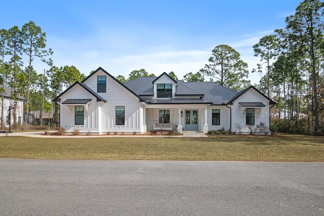 modern farmhouse featuring a front yard and covered porch