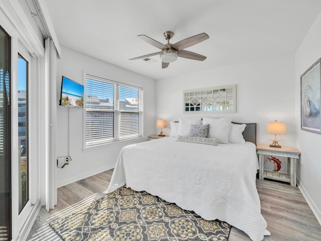 bedroom with ceiling fan and light hardwood / wood-style flooring