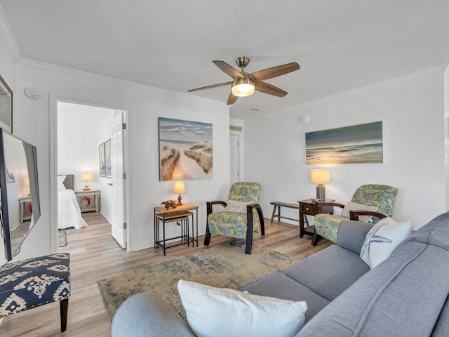 living room featuring crown molding, light hardwood / wood-style flooring, and ceiling fan