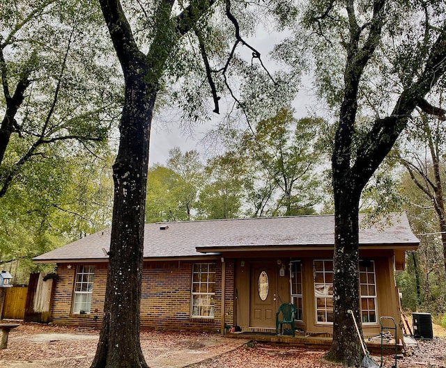 single story home featuring central air condition unit