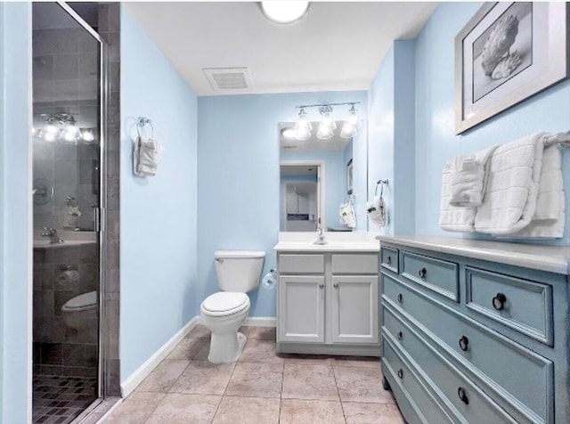 bathroom with toilet, visible vents, vanity, baseboards, and a stall shower