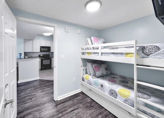 bedroom with dark wood-style floors and baseboards