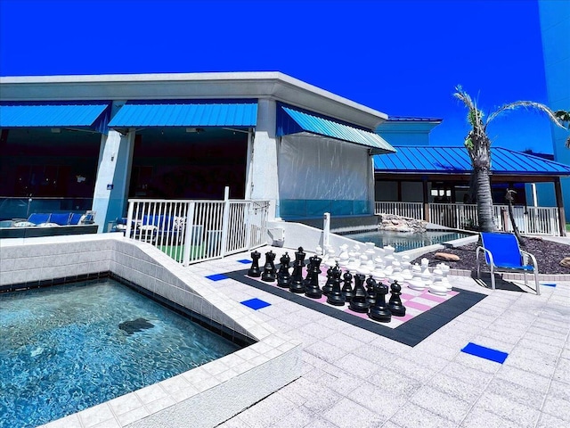 view of swimming pool with an in ground hot tub and a patio area