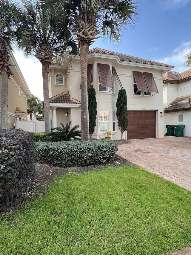 view of front of property with a garage and a front yard