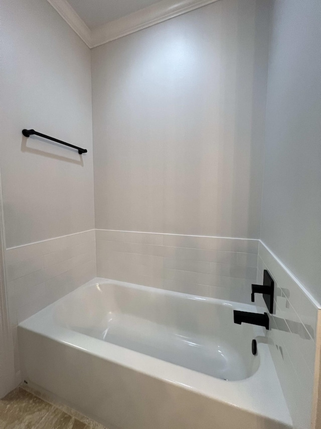 bathroom featuring a washtub and crown molding