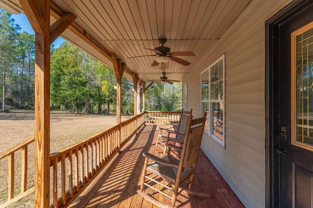 wooden deck with covered porch and ceiling fan