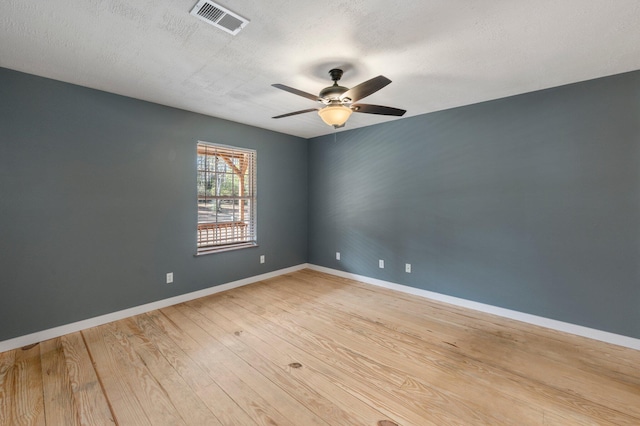 spare room with hardwood / wood-style flooring, a textured ceiling, and ceiling fan