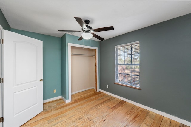 unfurnished bedroom with light hardwood / wood-style floors, a closet, and ceiling fan