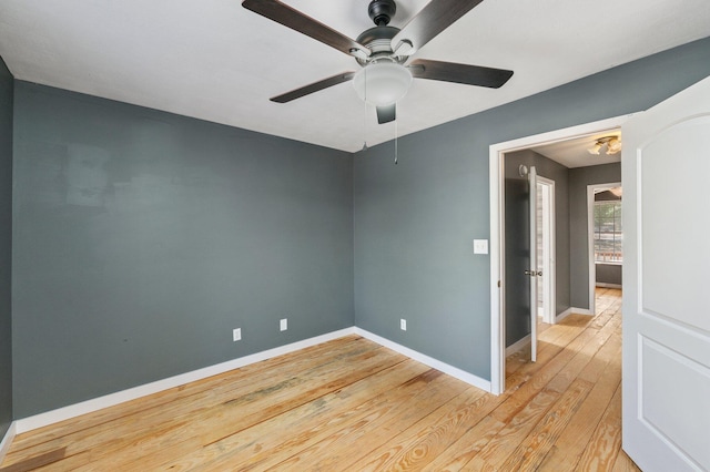 empty room with light hardwood / wood-style flooring and ceiling fan