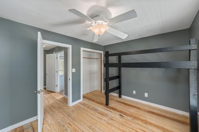 unfurnished bedroom with ceiling fan and light hardwood / wood-style floors